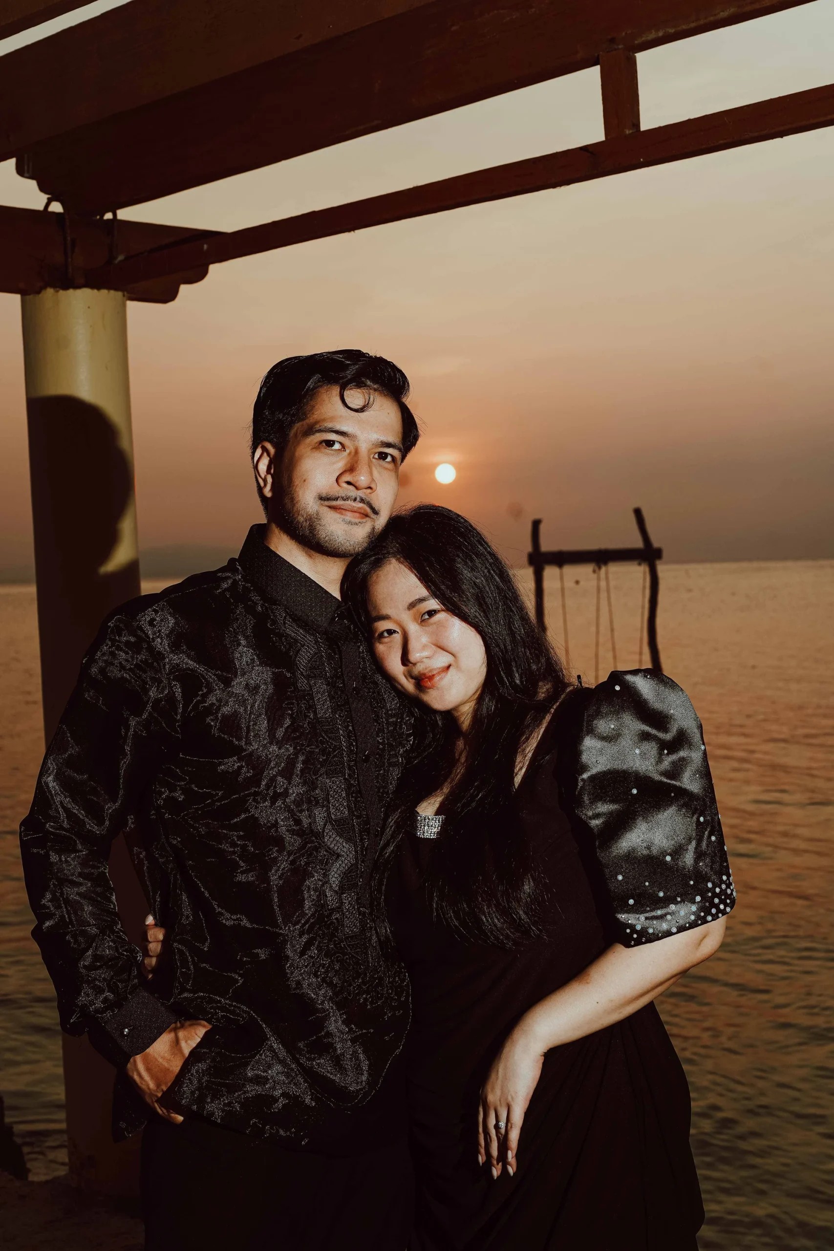 Couple silhouetted at sunset by the sea — cinematic wedding film still by Vivid Visuals, Philippines