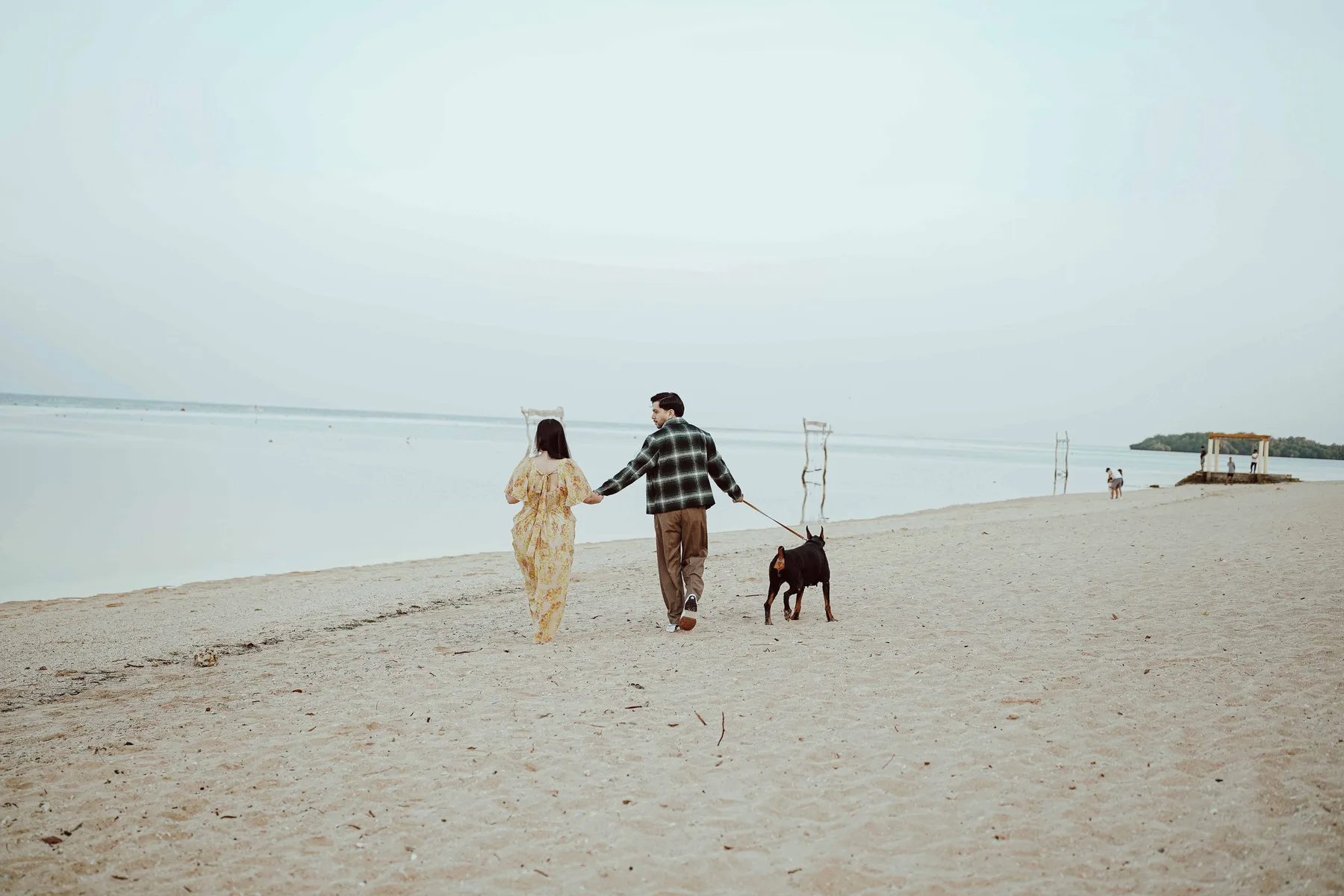 Couple walking their dog along the shore at golden hour, Batangas — by Vivid Visuals